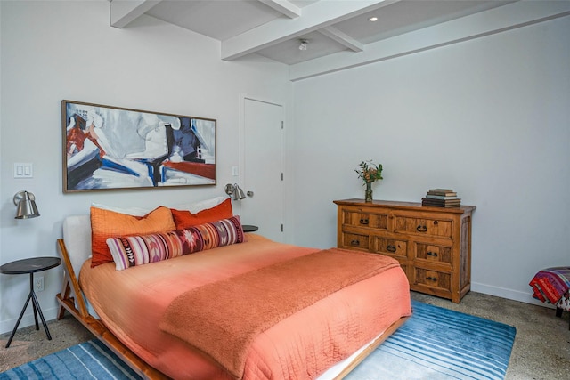 bedroom featuring baseboards and beamed ceiling