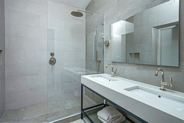 full bathroom with backsplash, tile walls, a walk in shower, and a sink