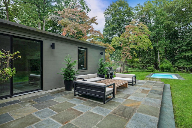 view of patio with a grill, an outdoor pool, and an outdoor living space