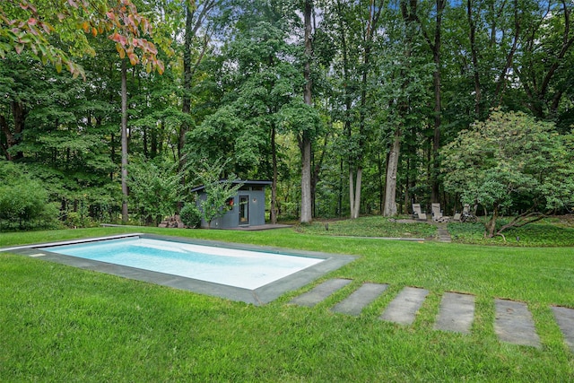 pool with a lawn, an outdoor structure, and an exterior structure