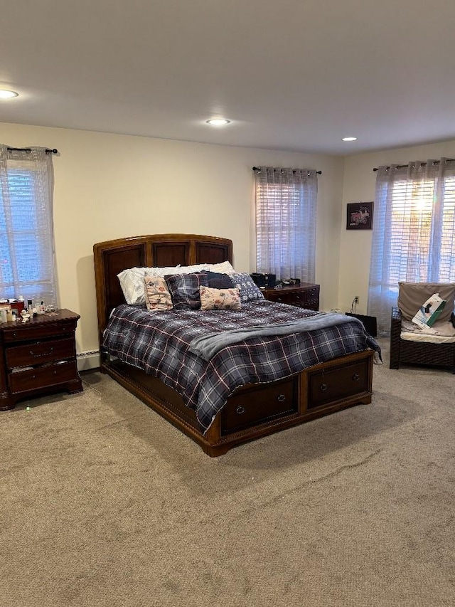 carpeted bedroom with a baseboard radiator