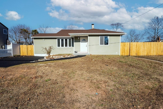 ranch-style home with a front lawn