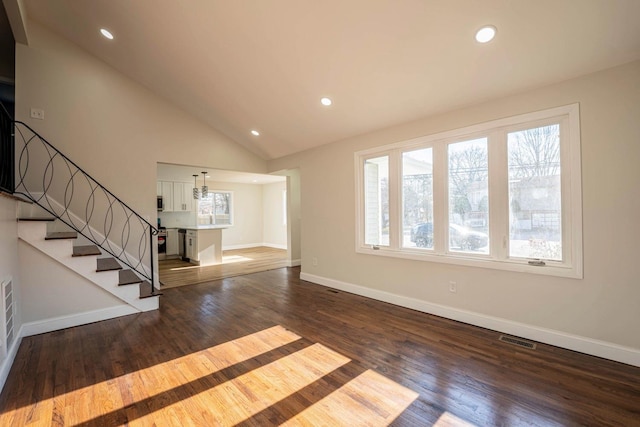 unfurnished living room featuring dark hardwood / wood-style flooring and high vaulted ceiling