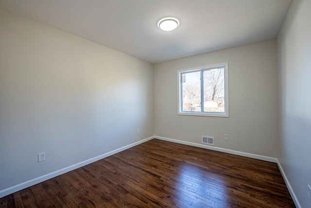 unfurnished room featuring dark wood-type flooring