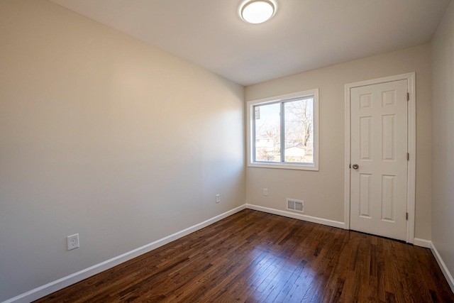 spare room featuring dark hardwood / wood-style flooring