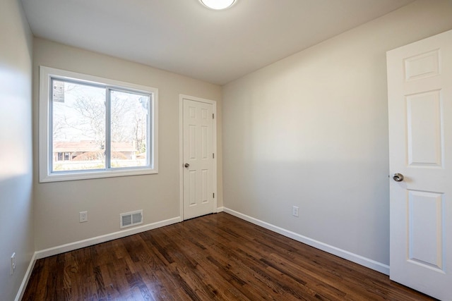 spare room featuring dark hardwood / wood-style flooring