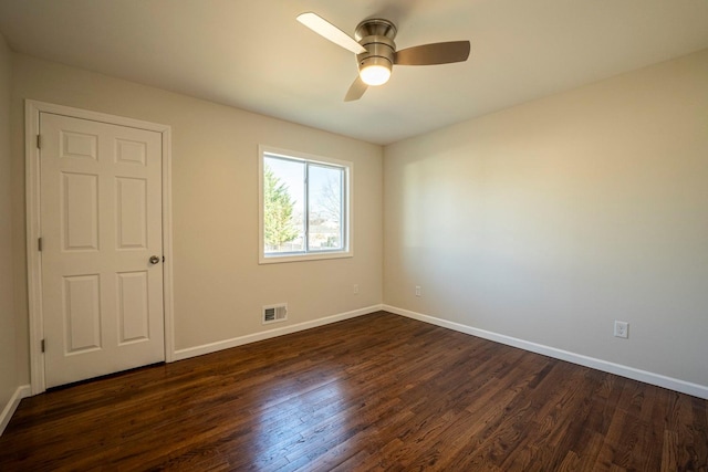 unfurnished room with dark hardwood / wood-style flooring and ceiling fan