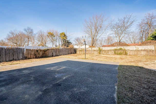 view of yard with basketball hoop