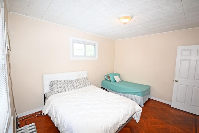 bedroom featuring dark parquet flooring