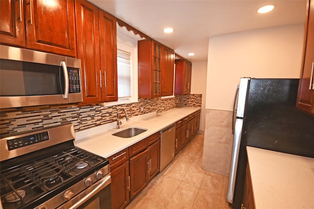 kitchen with light tile patterned floors, backsplash, stainless steel appliances, and sink