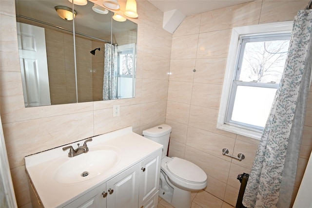 bathroom featuring vanity, toilet, tile walls, and curtained shower