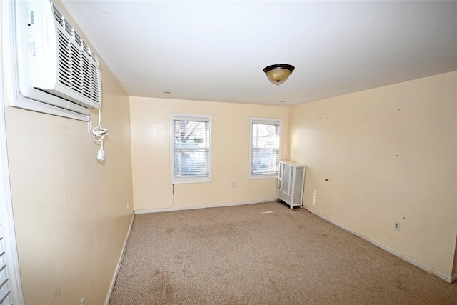 empty room featuring light carpet and a wall mounted AC