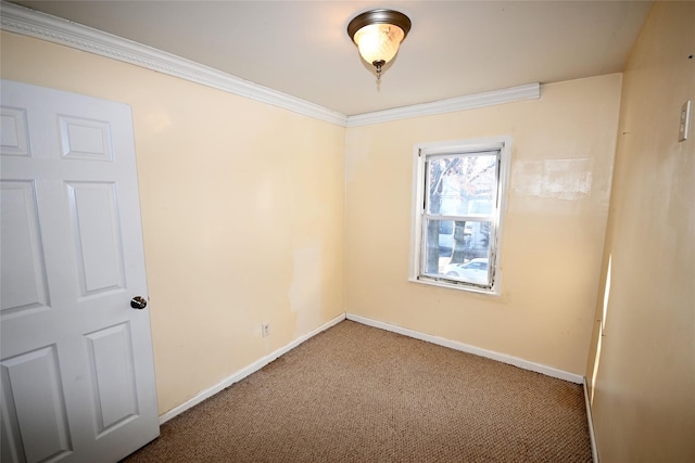 carpeted spare room with crown molding