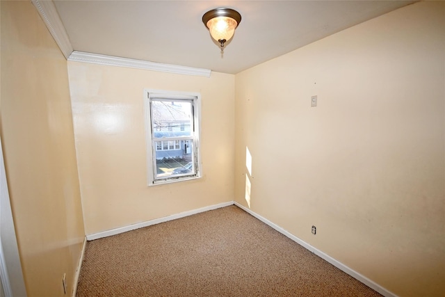 carpeted spare room with crown molding