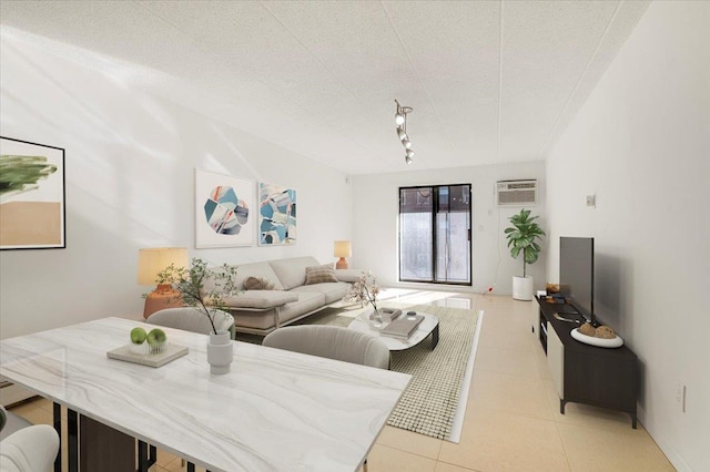 living room featuring a wall unit AC and light tile patterned floors