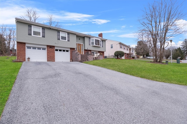 raised ranch with a garage and a front yard