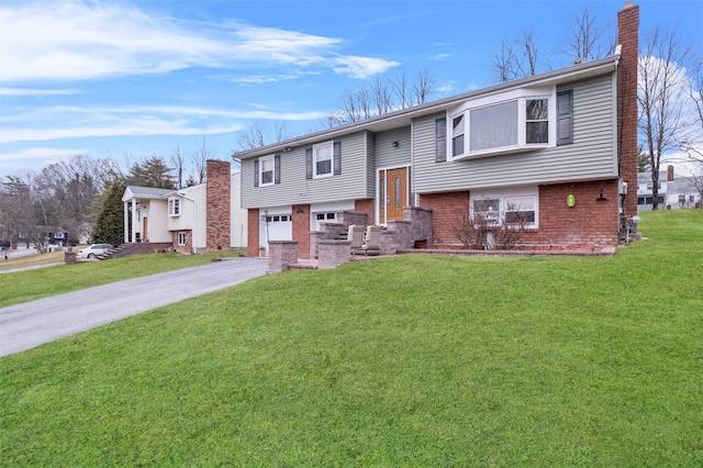 bi-level home with a garage and a front yard