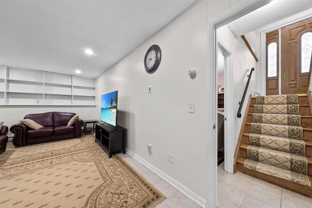 living room with built in features and light tile patterned floors