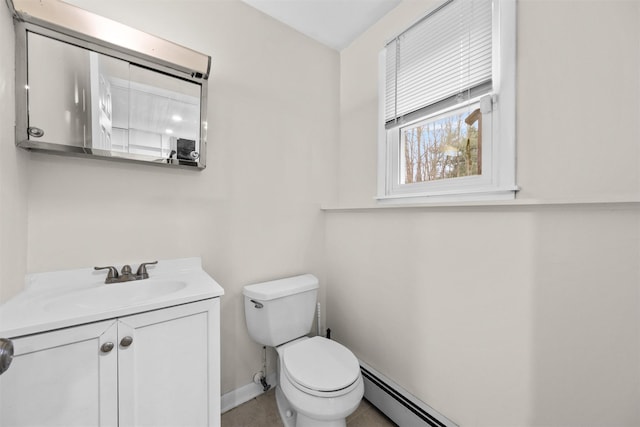 bathroom with tile patterned floors, vanity, a baseboard heating unit, and toilet