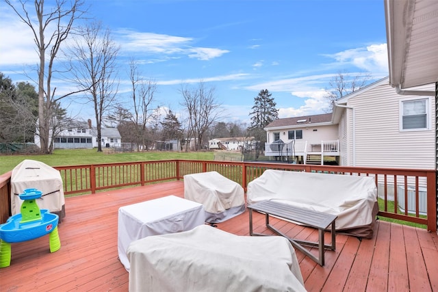 wooden deck with a lawn