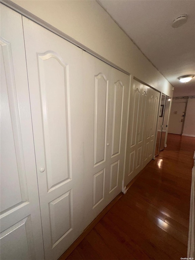 corridor featuring dark wood-type flooring