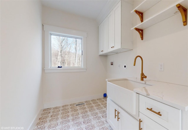 washroom with hookup for a washing machine, visible vents, cabinet space, electric dryer hookup, and baseboards