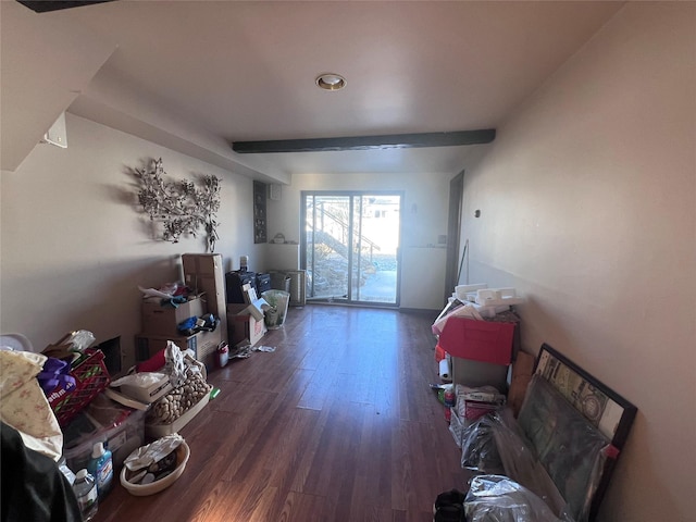 miscellaneous room featuring beam ceiling and dark wood-type flooring