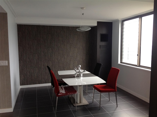 tiled dining area with a wealth of natural light and crown molding