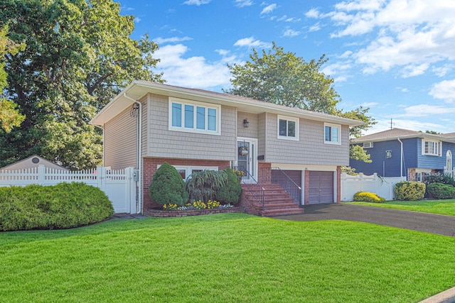 bi-level home with a front yard and a garage