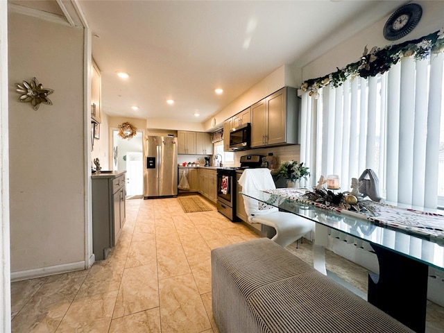 kitchen featuring appliances with stainless steel finishes, backsplash, and sink