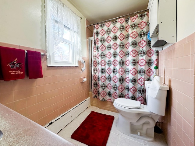 bathroom featuring tile patterned floors, toilet, tile walls, and a baseboard heating unit