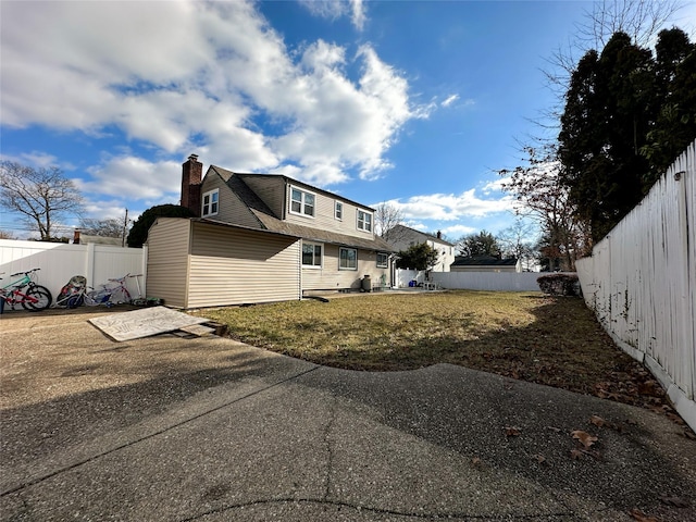 view of side of property with a lawn