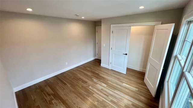 57 William St, Bethpage, NY 11714 - unfurnished bedroom featuring wood finished floors, recessed lighting, and a closet