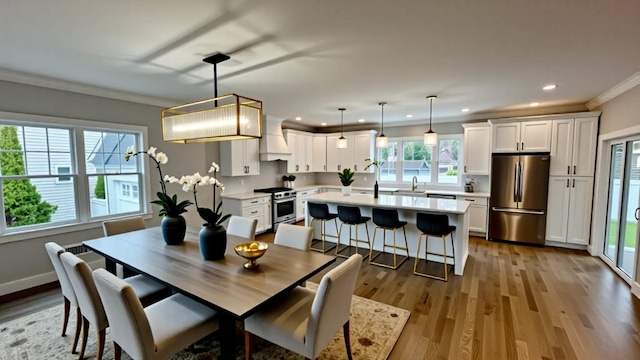 57 William St, Bethpage, NY 11714 - dining area featuring crown molding, wood finished floors, and recessed lighting