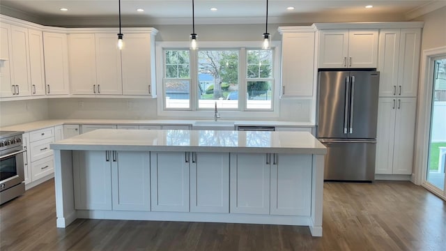 57 William St, Bethpage, NY 11714 - kitchen with appliances with stainless steel finishes, a center island, crown molding, plenty of natural light, and dark wood-style floors