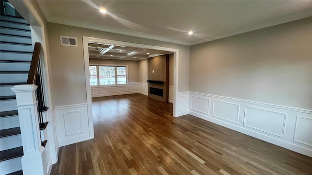 57 William St, Bethpage, NY 11714 - unfurnished room with a decorative wall, ornamental molding, stairway, dark wood-type flooring, and wainscoting