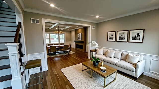 57 William St, Bethpage, NY 11714 - living room with stairway, ornamental molding, a decorative wall, a chandelier, and a wainscoted wall