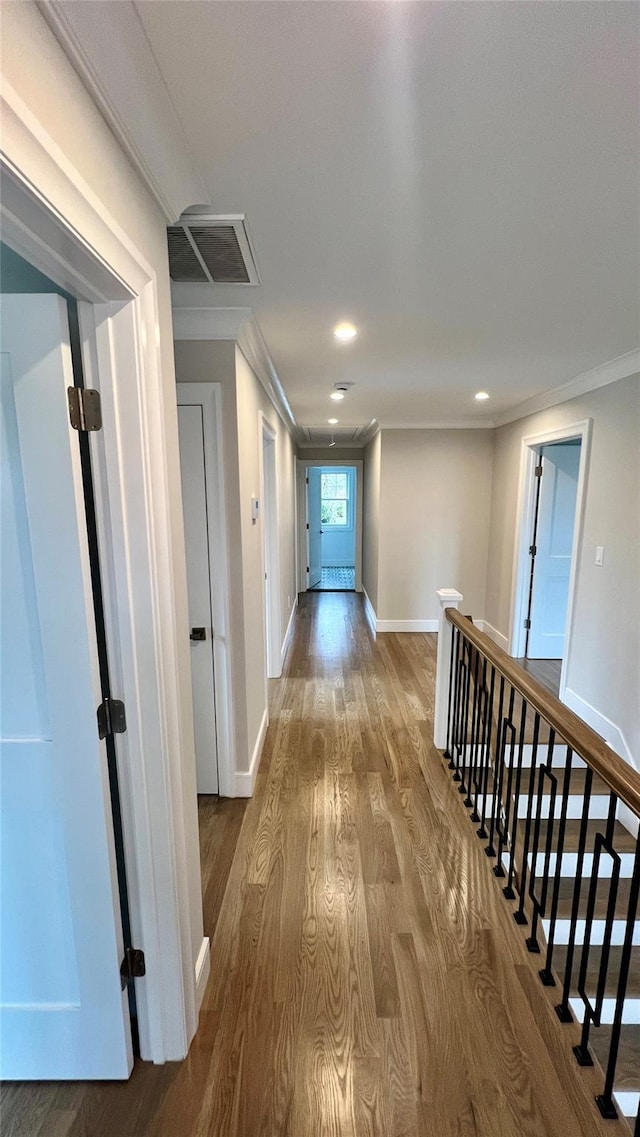 57 William St, Bethpage, NY 11714 - hall featuring ornamental molding, wood finished floors, recessed lighting, and an upstairs landing