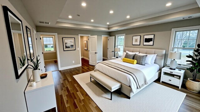 57 William St, Bethpage, NY 11714 - bedroom featuring a raised ceiling, dark wood finished floors, and recessed lighting