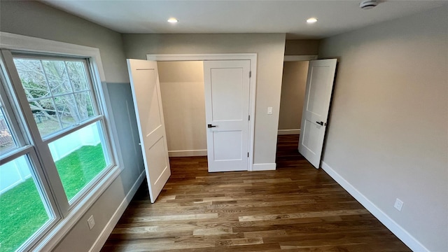 57 William St, Bethpage, NY 11714 - unfurnished bedroom with wood finished floors and recessed lighting