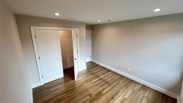 57 William St, Bethpage, NY 11714 - unfurnished bedroom with wood finished floors and recessed lighting