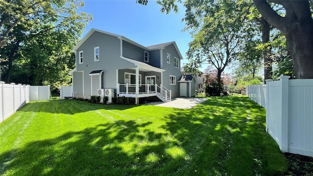 57 William St, Bethpage, NY 11714 - back of house featuring a fenced backyard and a shed