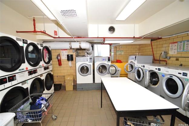 clothes washing area featuring independent washer and dryer and stacked washer and clothes dryer