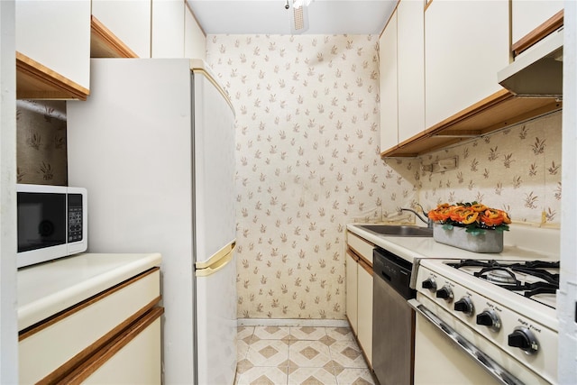 kitchen with white cabinetry, white appliances, and sink