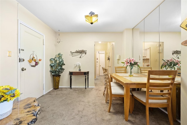 dining room with light colored carpet