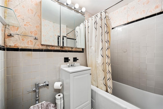 bathroom with vanity, tile walls, and shower / tub combo