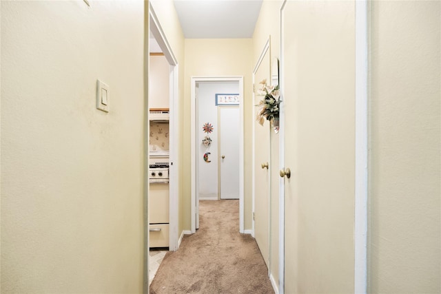 hallway with light colored carpet