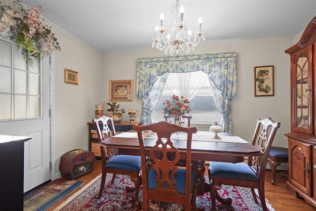 dining room featuring dark hardwood / wood-style floors and a notable chandelier