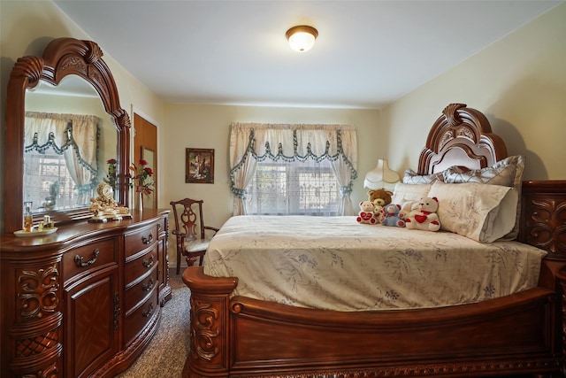 bedroom featuring dark carpet