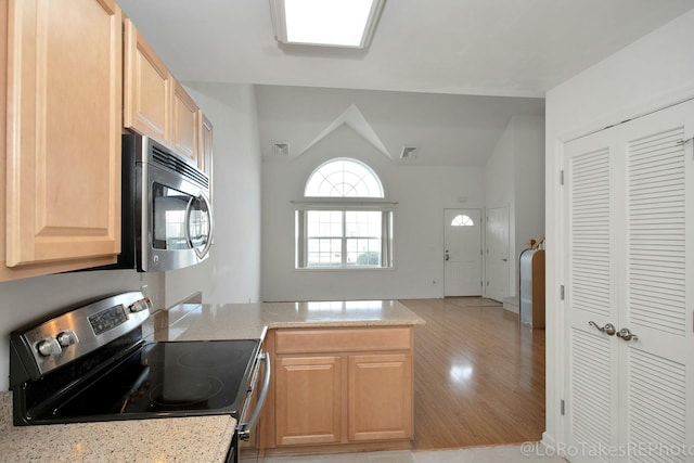 kitchen featuring light stone countertops, light brown cabinets, and appliances with stainless steel finishes